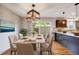 Elegant dining room with a table for six and sliding glass doors to the patio at 9026 E Mansfield Ave, Denver, CO 80237