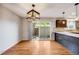 Bright dining area with hardwood floors and access to a private patio at 9026 E Mansfield Ave, Denver, CO 80237