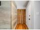 Inviting entryway with wood-look flooring and a slatted door at 9026 E Mansfield Ave, Denver, CO 80237