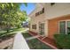 Brick townhouse exterior with a landscaped front yard and walkway at 9026 E Mansfield Ave, Denver, CO 80237