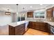 Modern kitchen with an island, hardwood floors, and updated cabinetry at 9026 E Mansfield Ave, Denver, CO 80237