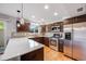 Modern kitchen with stainless steel appliances and ample counter space at 9026 E Mansfield Ave, Denver, CO 80237