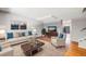 Bright living room with hardwood floors and a staged seating area at 9026 E Mansfield Ave, Denver, CO 80237