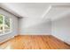 Bright living room featuring hardwood floors and large windows at 9026 E Mansfield Ave, Denver, CO 80237