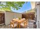 Patio with table and chairs, storage shed, and fence at 9026 E Mansfield Ave, Denver, CO 80237