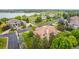 Stunning aerial view of home, showcasing lush landscaping, tile roof, and lake view at 14154 Lexington Cir, Westminster, CO 80023