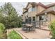 This backyard features a patio with an outdoor dining area and manicured landscaping at 14154 Lexington Cir, Westminster, CO 80023