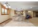 A charming basement bar area with tile flooring, cabinets, seating, and views of the stairs at 14154 Lexington Cir, Westminster, CO 80023