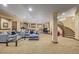 A large open basement area featuring a TV, workout area, bar and access to the staircase at 14154 Lexington Cir, Westminster, CO 80023