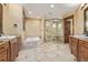 Spacious bathroom with a walk-in shower, soaking tub, double vanity, and tile flooring in a luxurious design at 14154 Lexington Cir, Westminster, CO 80023