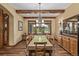 Elegant dining room with wood beams, hardwood floors, and large windows offering scenic views at 14154 Lexington Cir, Westminster, CO 80023