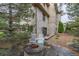 A stone fire pit is surrounded by chairs in a serene backyard setting at 14154 Lexington Cir, Westminster, CO 80023