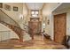 Elegant foyer with a grand staircase, hardwood floors, and custom millwork at 14154 Lexington Cir, Westminster, CO 80023