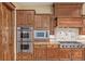 Close-up of the well-equipped kitchen with double ovens and a gas range at 14154 Lexington Cir, Westminster, CO 80023