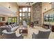 Bright living room features a stone fireplace, vaulted ceilings, and picture windows at 14154 Lexington Cir, Westminster, CO 80023