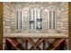 A stone wine cellar displaying racks for wine bottles and a wooden storage area at 14154 Lexington Cir, Westminster, CO 80023