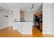 Bright kitchen with an island/peninsula, wooden cabinets, and black appliances at 9019 E Panorama Cir # D418, Englewood, CO 80112