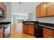 Open kitchen with granite countertops, stainless steel appliances, and hardwood floors at 9019 E Panorama Cir # D418, Englewood, CO 80112