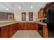 Practical kitchenette with appliances, cabinetry, and granite countertops at 9019 E Panorama Cir # D418, Englewood, CO 80112