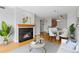 Inviting living room showcasing a fireplace, hardwood floors, and an adjacent dining area with an open layout at 9019 E Panorama Cir # D418, Englewood, CO 80112