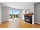 Spacious living room boasts a fireplace, hardwood floors, and a large sliding door to a balcony with neighborhood views at 9019 E Panorama Cir # D418, Englewood, CO 80112