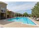 Relaxing community pool with lounge chairs and views of the building at 9019 E Panorama Cir # D418, Englewood, CO 80112