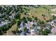 An aerial view showing neighborhood homes near a large green space with trees and a playground at 7296 S Flower St, Littleton, CO 80128