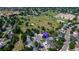 An aerial view of neighborhood homes near a school and green space featuring trees and a playground at 7296 S Flower St, Littleton, CO 80128