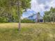 The home's backyard features a lawn, fencing, and mature trees at 7296 S Flower St, Littleton, CO 80128