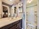 Bathroom featuring a vanity with sink and walk-in shower with tiled floor at 7296 S Flower St, Littleton, CO 80128