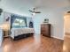 This bedroom features wood floors, a ceiling fan, and blue decorative accents at 7296 S Flower St, Littleton, CO 80128