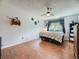 Bedroom with wood floors, ceiling fan, and decorations creating a charming atmosphere at 7296 S Flower St, Littleton, CO 80128