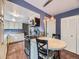 Functional kitchen featuring white cabinets, a breakfast table, and modern appliances, perfect for cooking at 7296 S Flower St, Littleton, CO 80128