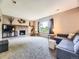 Comfortable living room with brick fireplace and large window with outdoor views at 7296 S Flower St, Littleton, CO 80128