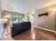 Inviting living room with hardwood floors, large windows, and neutral paint, showcasing a cozy atmosphere at 7296 S Flower St, Littleton, CO 80128