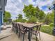 Spacious patio with outdoor table and chairs, and a view of the backyard and landscaping at 7296 S Flower St, Littleton, CO 80128