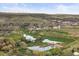 Scenic aerial view showcasing a lush golf course with water features nestled in a green, hilly landscape and neighborhood at 828 Rabbit Run Dr, Golden, CO 80401