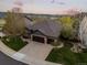 Aerial view of a landscaped home with a spacious driveway and mountain views at 828 Rabbit Run Dr, Golden, CO 80401