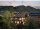 A backyard view featuring lush greenery, mature trees and mountain views at 828 Rabbit Run Dr, Golden, CO 80401