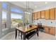 Dining area with mountain views from large windows and a nearby built in workstation at 828 Rabbit Run Dr, Golden, CO 80401