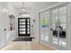 Bright entryway features modern door, stylish light fixture, and warm wood floors, creating an inviting ambiance at 828 Rabbit Run Dr, Golden, CO 80401