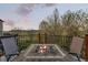 Outdoor fire table with seating on a deck, perfect for enjoying evenings outdoors with scenic views at 828 Rabbit Run Dr, Golden, CO 80401
