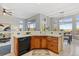 Well-lit kitchen with wood cabinets, white counters, and stainless steel dishwasher at 828 Rabbit Run Dr, Golden, CO 80401
