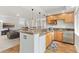 Wet bar area with sink, min-fridge, and counter seating features light wood cabinetry at 828 Rabbit Run Dr, Golden, CO 80401