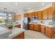 Bright kitchen featuring wood cabinets, stainless steel appliances, and quartz countertops, perfect for cooking at 828 Rabbit Run Dr, Golden, CO 80401