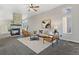 Cozy living room featuring a stone fireplace, plush seating, and large windows at 828 Rabbit Run Dr, Golden, CO 80401