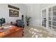 Comfortable office space featuring wood floors, a sleek desk, and view from the glass paneled office door at 828 Rabbit Run Dr, Golden, CO 80401