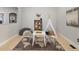 Charming playroom with playful décor, including a teepee, mini table set, and world map rug at 828 Rabbit Run Dr, Golden, CO 80401