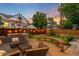 Backyard with deck, couch, and festive string lights and a manicured yard at 840 S Gaylord St, Denver, CO 80209