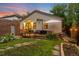 Backyard with wooden deck, table and chairs and a beautiful lawn at 840 S Gaylord St, Denver, CO 80209